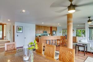 a kitchen and living room with a table and chairs at Hilo Home with Private Deck and Stunning Ocean Views! in Hilo
