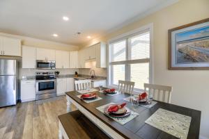 a kitchen with a table and a dining room at Pet-Friendly Emerald Isle Vacation Rental! in Emerald Isle