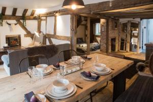 a wooden table with plates and bowls on it at West Street Loft in Midhurst