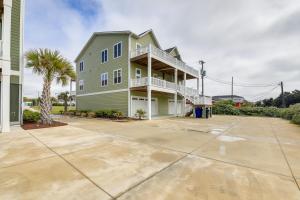 a large green house with a large driveway at Pet-Friendly Emerald Isle Vacation Rental! in Emerald Isle