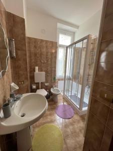 a bathroom with a sink and a toilet and a shower at Le Betulle in Oggebbio