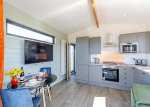 a kitchen with a table and a dining room at Belan View Lodges in Welshpool