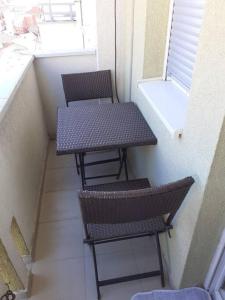 uma pequena mesa e duas cadeiras numa pequena varanda em Apartment Dastidi em Kosovska Mitrovica