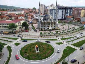 a roundabout in a city with cars on a street at Apartment Dastidi in Mitrovica