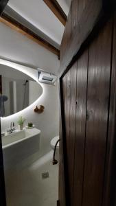 a bathroom with a sink and a toilet and a mirror at Limeri Traditional Guest House in Monólithos