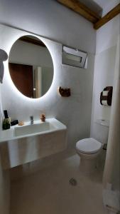 a bathroom with a sink and a toilet and a mirror at Limeri Traditional Guest House in Monólithos