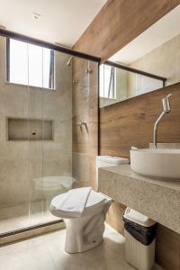 a bathroom with a toilet and a sink and a shower at Bravo Pousada Design in Cabo Frio