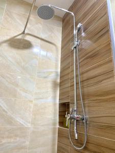 a shower in a bathroom with a glass wall at 12-10 Twin bedroom in Formosa Residence Nagoya Batam 3 pax by Wiwi in Nagoya