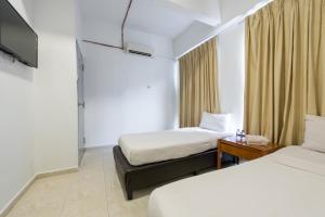 Postel nebo postele na pokoji v ubytování Hollitel Hotel