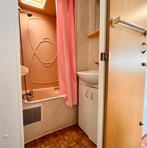 a small bathroom with a sink and a toilet at Domki na Ogrodowej in Trzęsacz