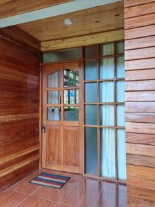 a wooden door in a room with wooden walls at La Ramada de Mama Elena in Oxapampa