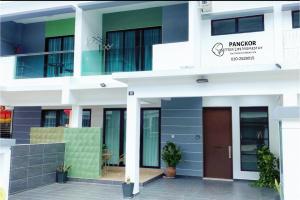 a facade of a building with a brown door at Pangkor Villa88 Double Storey 3min to Pasir Bogak Beach in Pangkor