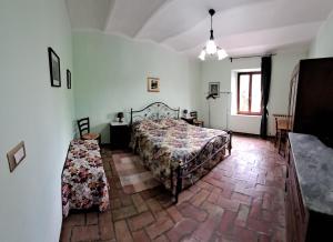 a bedroom with a bed and a table in it at San Lorenzo in Cerreto dʼEsi