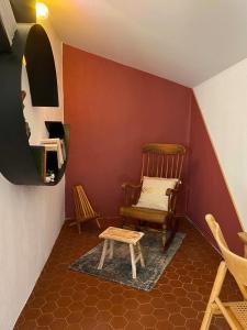 a corner of a room with a chair and a table at Mas Bella Vida in Puget-Théniers