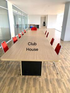 a conference table in an office with a club house sign on it at 12-10 Twin bedroom in Formosa Residence Nagoya Batam 3 pax by Wiwi in Nagoya