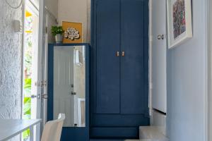 a blue door in a hallway with a staircase at Private Studio Good Vibes in Miami