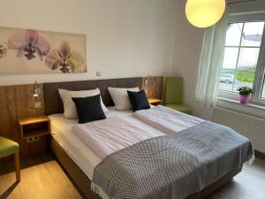 a bedroom with a large bed with two fans at Weingut Bernd Hermes in Kröv