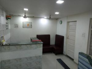 a waiting room with two chairs and a desk at Hotel janata Residency in Mumbai