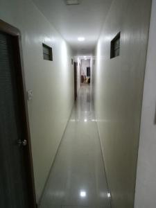 a hallway of a building with a long white wall at Hotel janata Residency in Mumbai