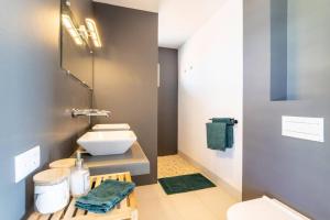 a small bathroom with a sink and a toilet at Stylish Apartment with Swimming Pool in Kralendijk