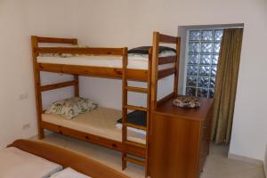 a bedroom with two bunk beds and a desk at Apartma Praprot in Mojstrana