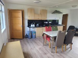 a kitchen and dining room with a table and chairs at The Cabin Getaway in Derry Londonderry