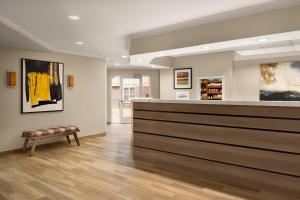 a lobby with a counter and a bench in a room at Residence Inn by Marriott Chicago / Bloomingdale in Bloomingdale