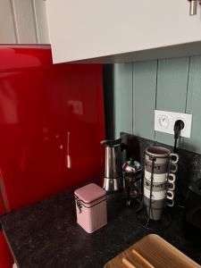 a kitchen with a counter top with a pink container at Nid douillet T2 wifi centre historique 3 étoiles in La Rochelle +22 photos