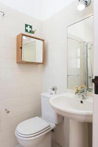 a white bathroom with a toilet and a sink at Aldeia do Golfe - Private condominium by HD in Vilamoura