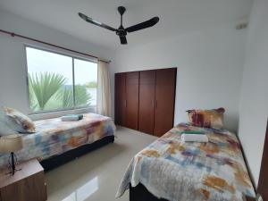 a bedroom with two beds and a large window at Ibiza Reservado 201 in Melgar