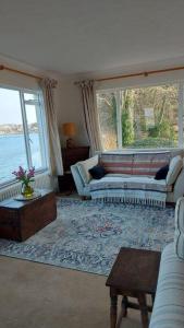 a living room with a couch and a table at Brooklands Farm Hamble Riverside apartment on the reiver in Southampton