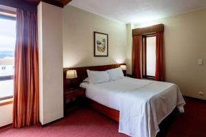 Postel nebo postele na pokoji v ubytování Hotel A.S. Sao Joao da Madeira