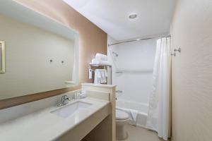 a bathroom with a sink and a toilet and a mirror at Fairfield by Marriott Inn & Suites Uncasville Mohegan Sun Area in Uncasville