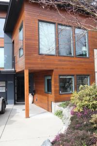 a wooden house with windows on a street at Galloping Goose B&B in Beautiful Victoria in Victoria