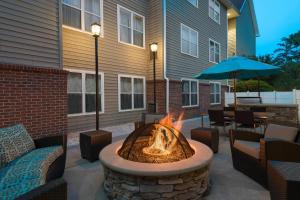 a patio with a fire pit in front of a building at Residence Inn Savannah Midtown in Savannah