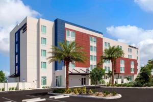 a rendering of a hotel with palm trees in a parking lot at SpringHill Suites by Marriott Punta Gorda Harborside in Punta Gorda