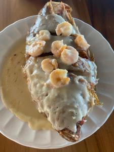 a white plate with a piece of food with sauce at Ecohotel La Reserva in Piojó