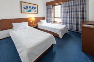 Postel nebo postele na pokoji v ubytování Hotel A.S. Sao Joao da Madeira