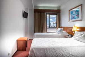 Postel nebo postele na pokoji v ubytování Hotel A.S. Sao Joao da Madeira