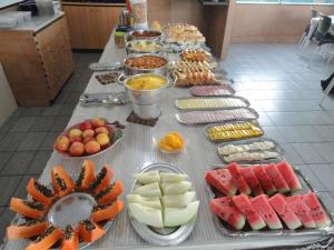 a table with many different types of food on it at Pousada São Luiz in Aracaju