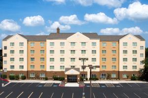 a large white building with a parking lot at Fairfield Inn & Suites by Marriott San Antonio Airport/North Star Mall in San Antonio