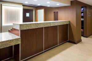 a lobby with wooden walls and a counter top at Fairfield Inn & Suites by Marriott San Antonio Airport/North Star Mall in San Antonio