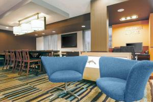 a waiting room with blue chairs and a table at Fairfield Inn & Suites by Marriott San Antonio Airport/North Star Mall in San Antonio