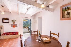 a living room with a wooden table and a couch at Olive Grove Cottage in Karpathos