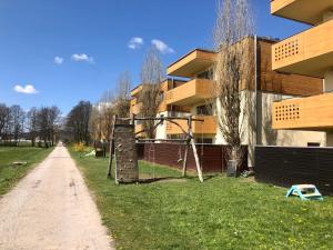 einen Spielplatz im Gras neben einem Gebäude in der Unterkunft Jenny Apartment with Jacuzzi in Brezovica