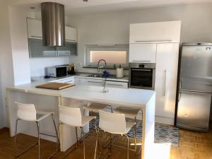 a kitchen with a white counter and white appliances at Jenny Apartment with Jacuzzi in Brezovica