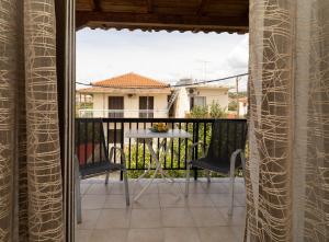 a patio with a table and chairs on a balcony at Tsimiklis Apartments in Finikounta