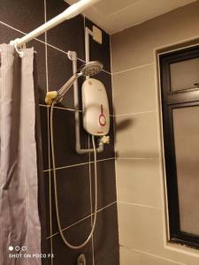 a shower head on a wall in a bathroom at HP402- Two Bedroom Apartment- Wifi- Netflix- Parking- Cyberjaya -New, 3061 in Cyberjaya