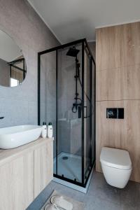 a bathroom with a glass shower and a toilet at B-LESS in Blankenberge