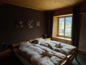 a bedroom with two dolls laying on a bed at Auberge de l'Ange in Albeuve